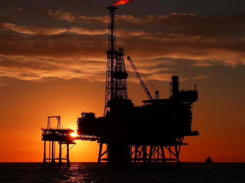 Oil Platform Jobs offshore drilling rig at sunset in the middle of the sea